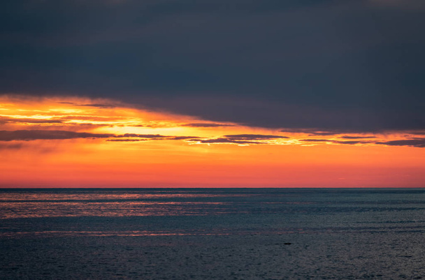 Beautiful red and orange sunset over the sea. - 写真・画像