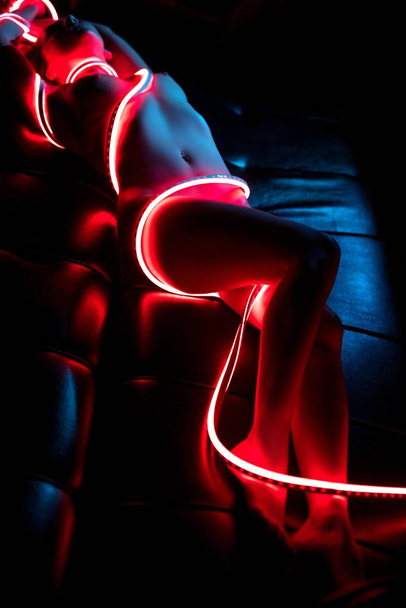 Nude woman wrapped in leds high angle shot - Foto, imagen
