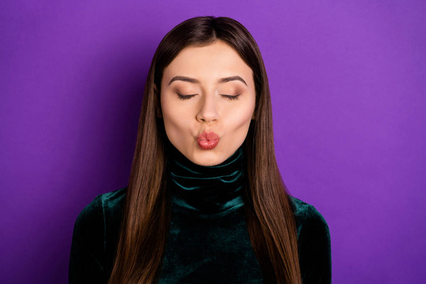 Close up photo of pretty woman with her eyes closed sending air kisses isolated over purple violet background - Fotó, kép