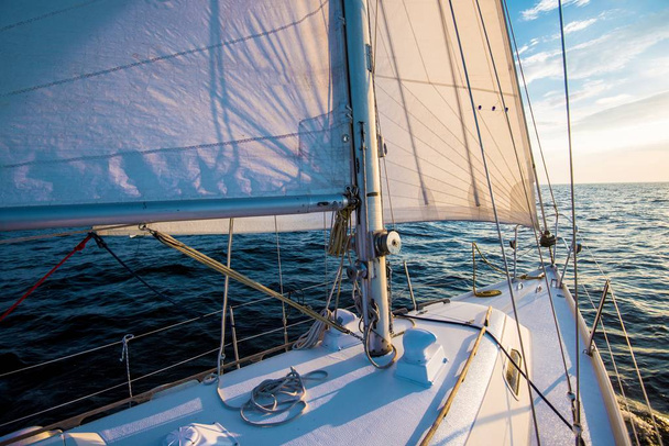 Sailing at sunset. A view from the yacht's deck to the bow and sails. Close-up. Baltic sea, Latvia - Photo, Image
