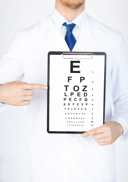 Male ophthalmologist with eye chart - Фото, зображення