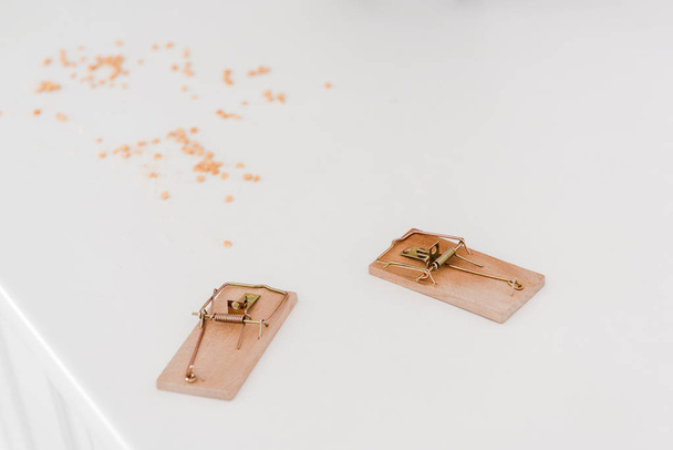 wooden mousetraps near lentils on white table  - Photo, Image