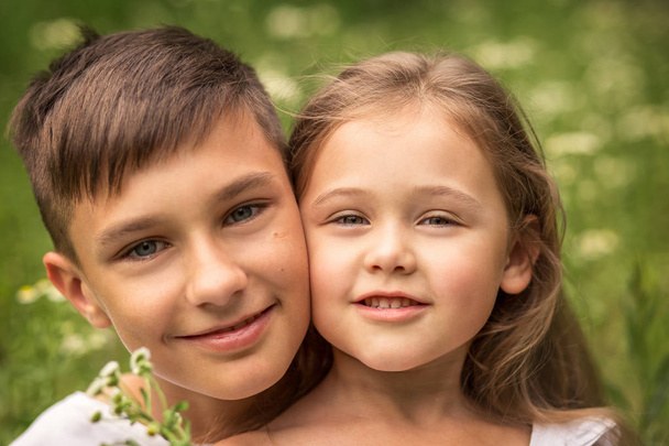 close-up portrait of brother and sister outdoors in summer - Photo, Image