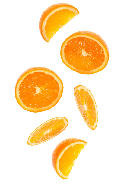falling fresh orange fruit slices isolated on white background c - Фото, изображение