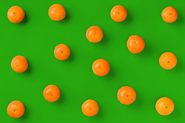 Fruit pattern of fresh orange tangerine or mandarin on green bac - 写真・画像