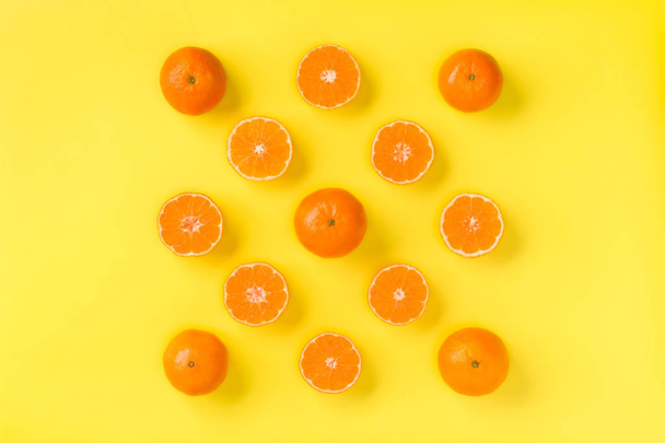 Fruit pattern of fresh mandarin slices on yellow background. Fla - Fotó, kép
