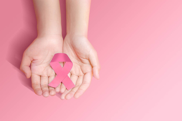 Human hands showing pink awareness ribbon - Foto, Bild