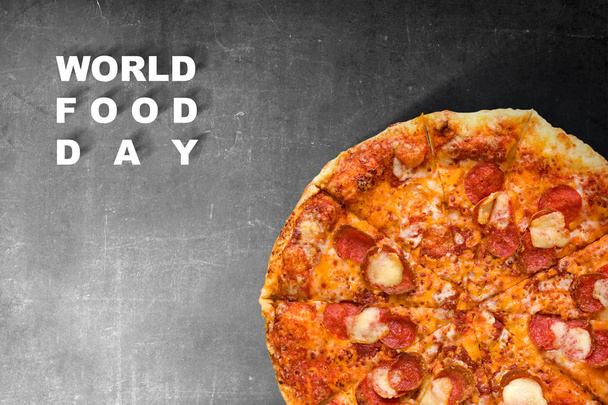 Pizza with World Food Day text on black background - Foto, afbeelding