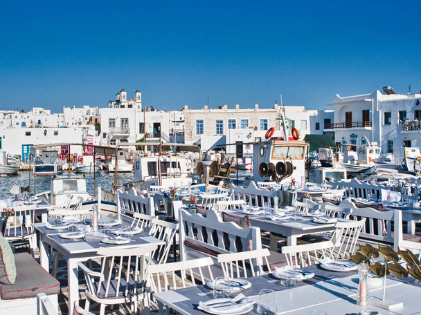 Empty Greek tavern in harbor on daytime - 写真・画像