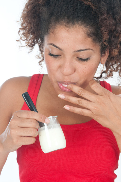 Girl eating a yoghurt - Foto, Imagen