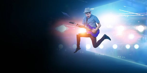 Guitar player in motion on stadium - Photo, Image