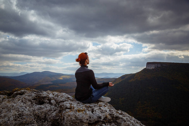 young fitness woman practice yoga at mountain peak cliff edge - Photo, Image