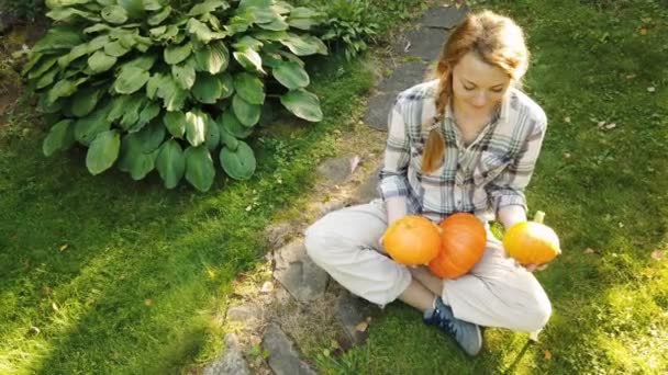 Mooie vrouw in de tuin met pompoenen - Video