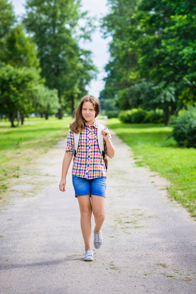 Beautiful teenager girl in casual clothes going to school on sunny september day, outdoor portrait - Fotografie, Obrázek