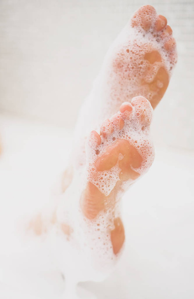Woman legs in bath with milk. SPA treatments for skin care. - Zdjęcie, obraz