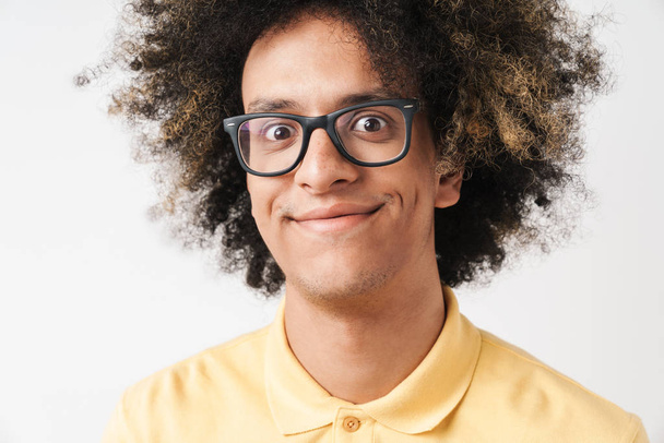 Photo of pleased caucasian man with afro hairstyle wearing eyegl - Fotó, kép