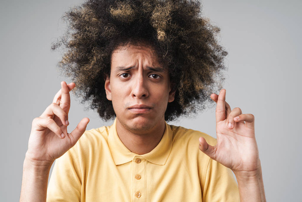 Photo of perplexed caucasian man with afro hairstyle frowning an - Foto, imagen