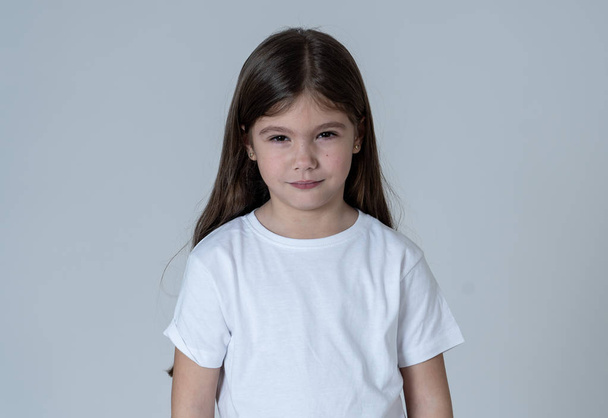 Portrait of a cute pretty child girl looking angry and disappointed with her arms crossed. Isolated on neutral background. In children feelings and behaviour and human emotions and expressions. - Zdjęcie, obraz