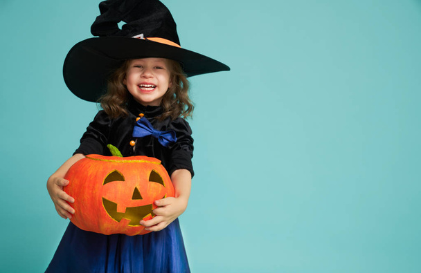 little witch on turquoise background - 写真・画像