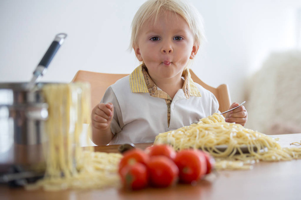Little baby boy, toddler child, eating spaghetti for lunch and m - Foto, Imagen
