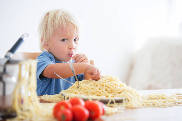 Little baby boy, toddler child, eating spaghetti for lunch and m - Φωτογραφία, εικόνα