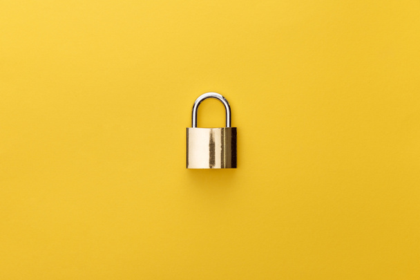 top view of metal padlock on yellow background - Photo, Image