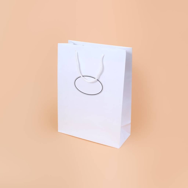 White paper bag isolated on simple background - Fotó, kép