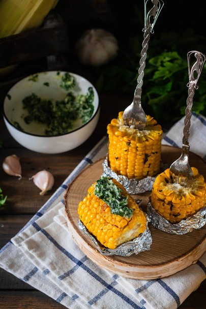 Baked corn with spiced butter on a rustic wooden background. Barbecue food. Thanksgiving Day. Autumn harvest. - Photo, Image