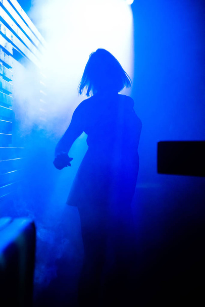 photo of a dancing girl in smoke - Foto, Imagem