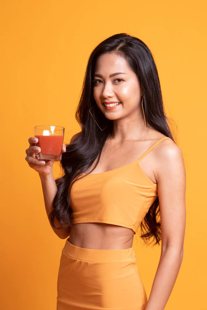 Young Asian woman drink tomato juice. - Фото, зображення