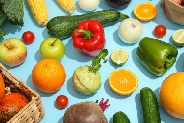 Different vegetables and fruits on blue background. Healthy food - Zdjęcie, obraz