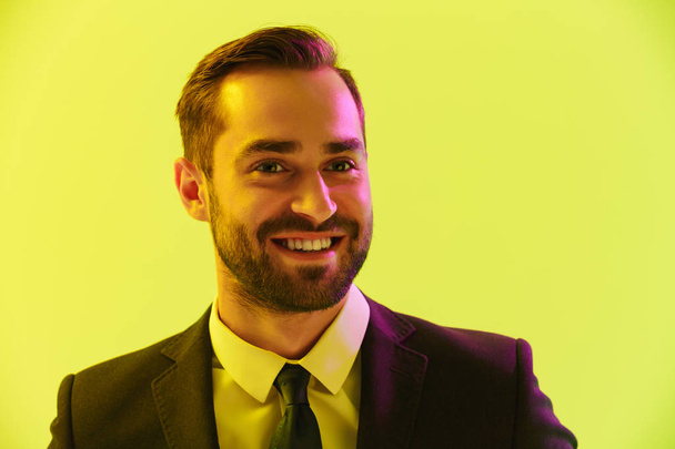 Image closeup of happy young businessman in formal suit smiling at camera - Fotó, kép
