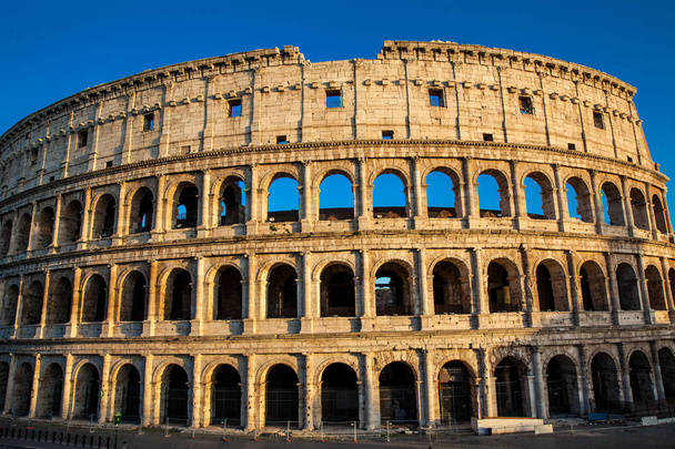 The famous Colosseum under the beautiful light of the golden hour in Rome - Photo, Image