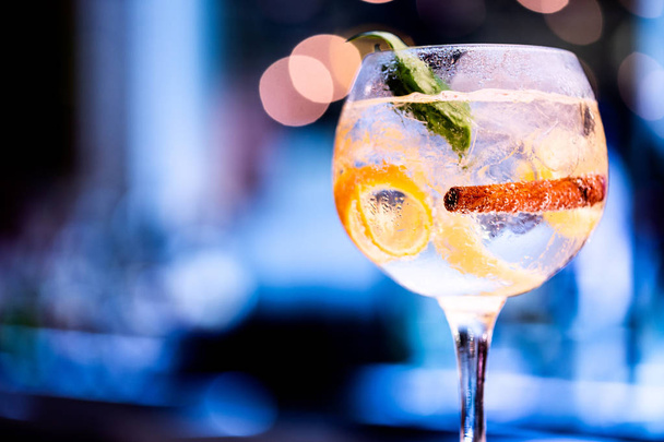 Beautiful glass of gin on bar counter, with blurred background. Hero perspective . - Photo, Image