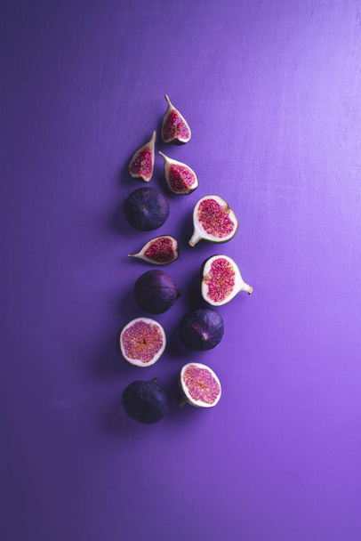 Fresh figs on a purple background. Sliced figs  - Photo, Image