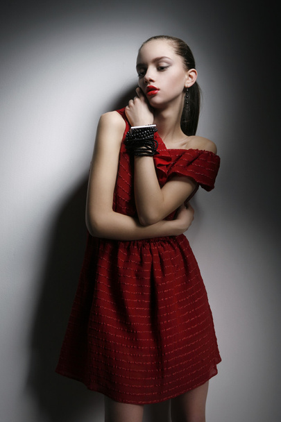 Pretty woman in red dress, with beauty make-up and jewelry - Zdjęcie, obraz