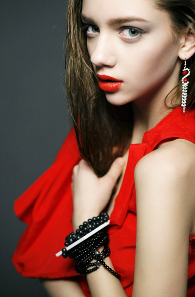 Woman with bright make-up, jewelry and red dress - Фото, изображение