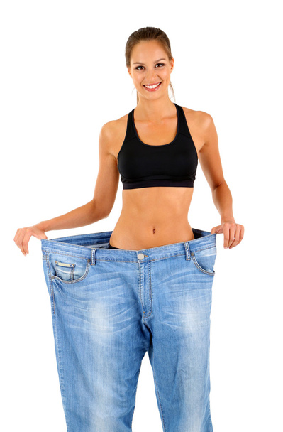 Slim girl in big jeans isolated on white - Fotografie, Obrázek