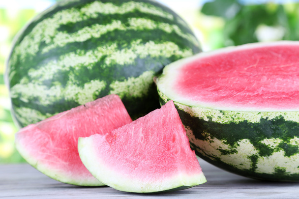 Ripe watermelons on wooden table on nature background - Foto, Imagen