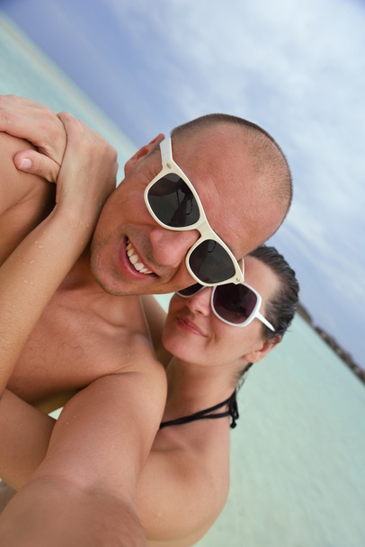 happy young couple have fun on beach - 写真・画像