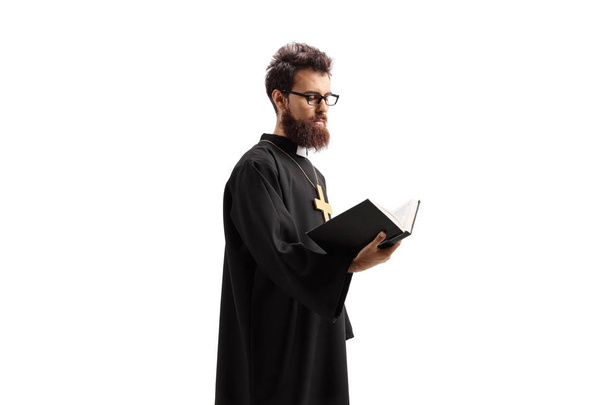 Priest standing and reading the Bible - Zdjęcie, obraz