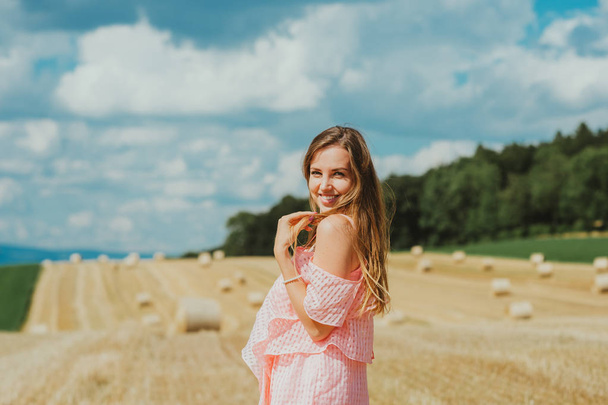 Outdoor portrait of beautiful young woman in countryside - Photo, Image