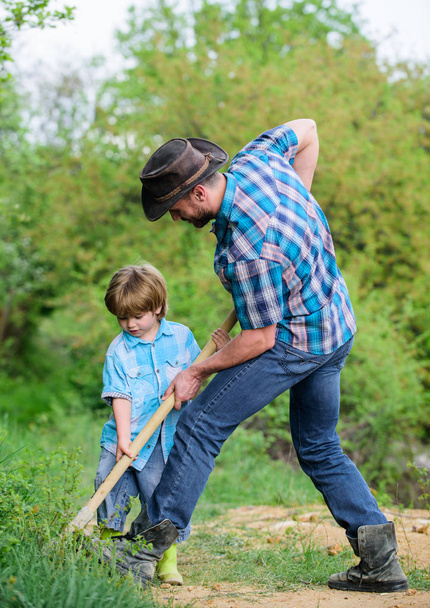 Little helper working in garden. Cute child in nature having fun with shovel. Find treasures. Little boy and father with shovel looking for treasures. Happy childhood. Adventure hunting for treasures - Photo, Image