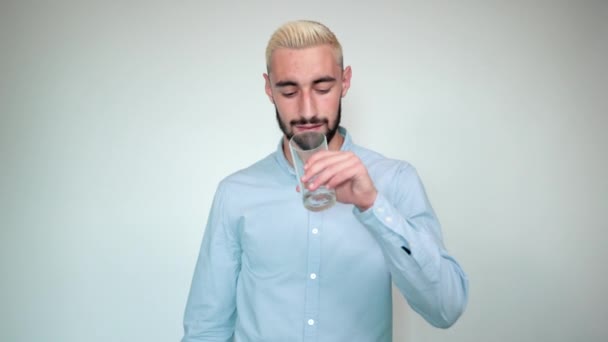 άντρας με ξανθά μαλλιά, μαύρο μούσι πάνω από απομονωμένο λευκό φόντο δείχνει συναισθήματα - Πλάνα, βίντεο