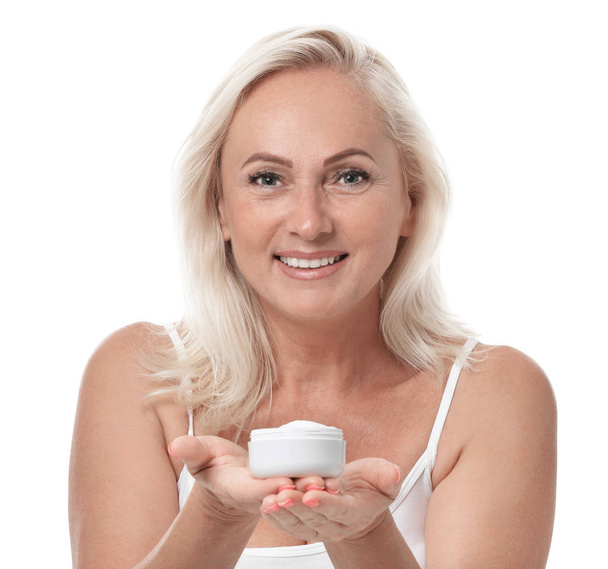Portrait of beautiful mature woman with perfect skin holding jar of cream on white background - Foto, immagini