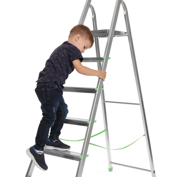 Little child climbing up ladder on white background. Danger at home - Foto, afbeelding