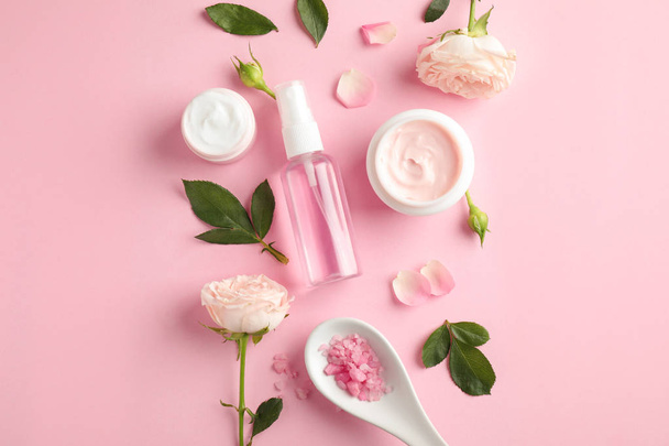Flat lay composition with rose essential oil on pink background - Fotografie, Obrázek