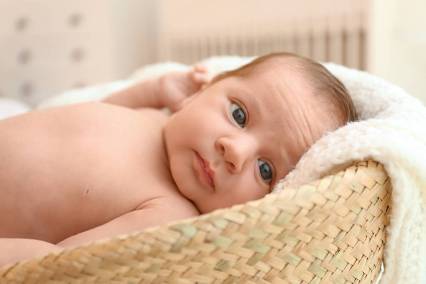Cute little baby lying on knitted plaid in cradle - Фото, зображення