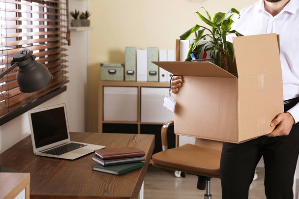 Businessman with moving box in office, closeup. Work promotion concept - Φωτογραφία, εικόνα