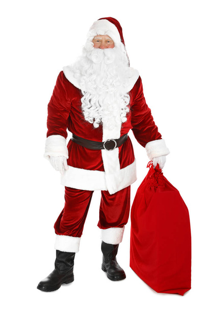 Aito Joulupukki pussi täynnä lahjoja valkoisella taustalla
 - Valokuva, kuva
